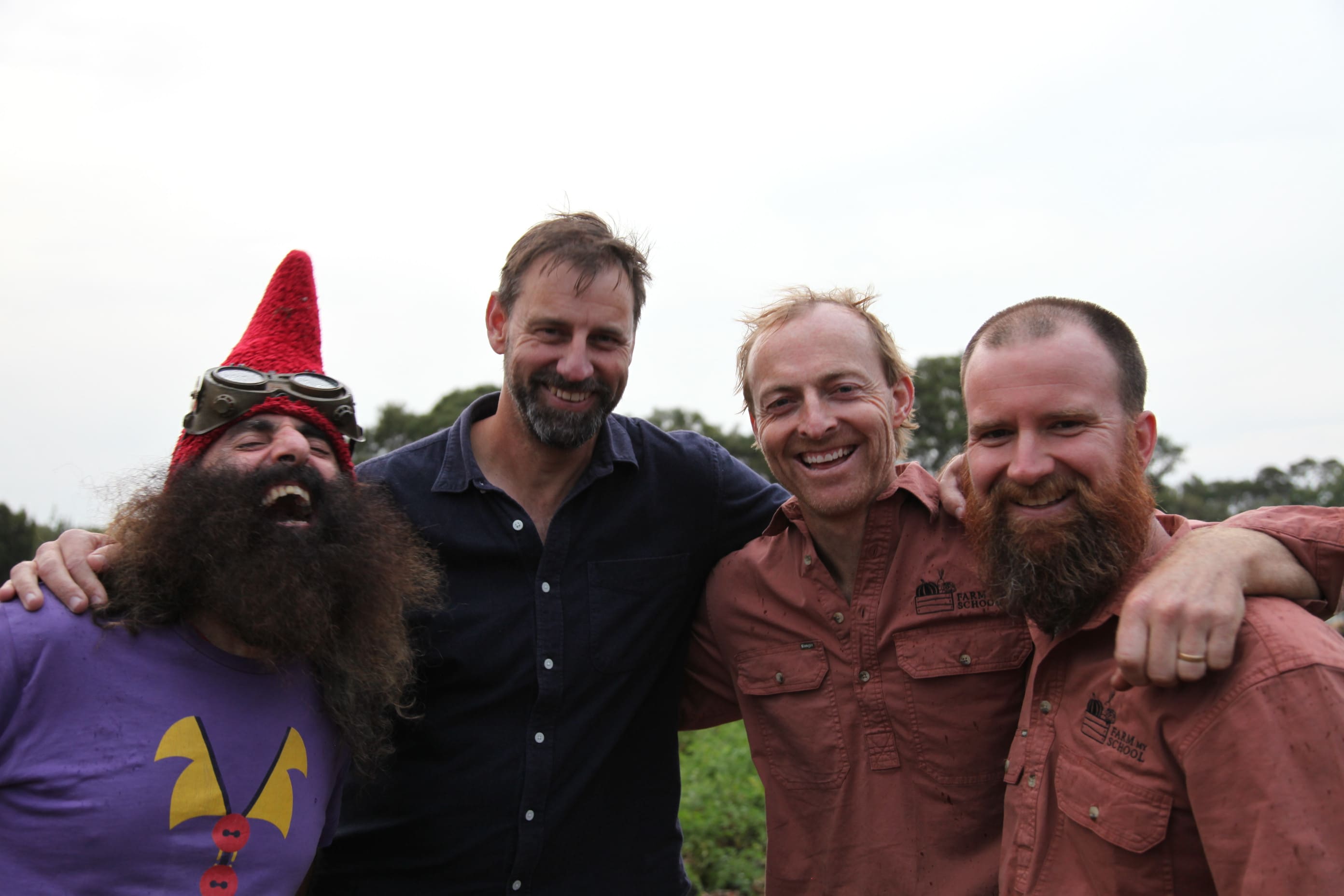 Farm My School team members smiling together, reflecting the not-for-profit’s diverse expertise in food security, environmental conservation, education, and community development.