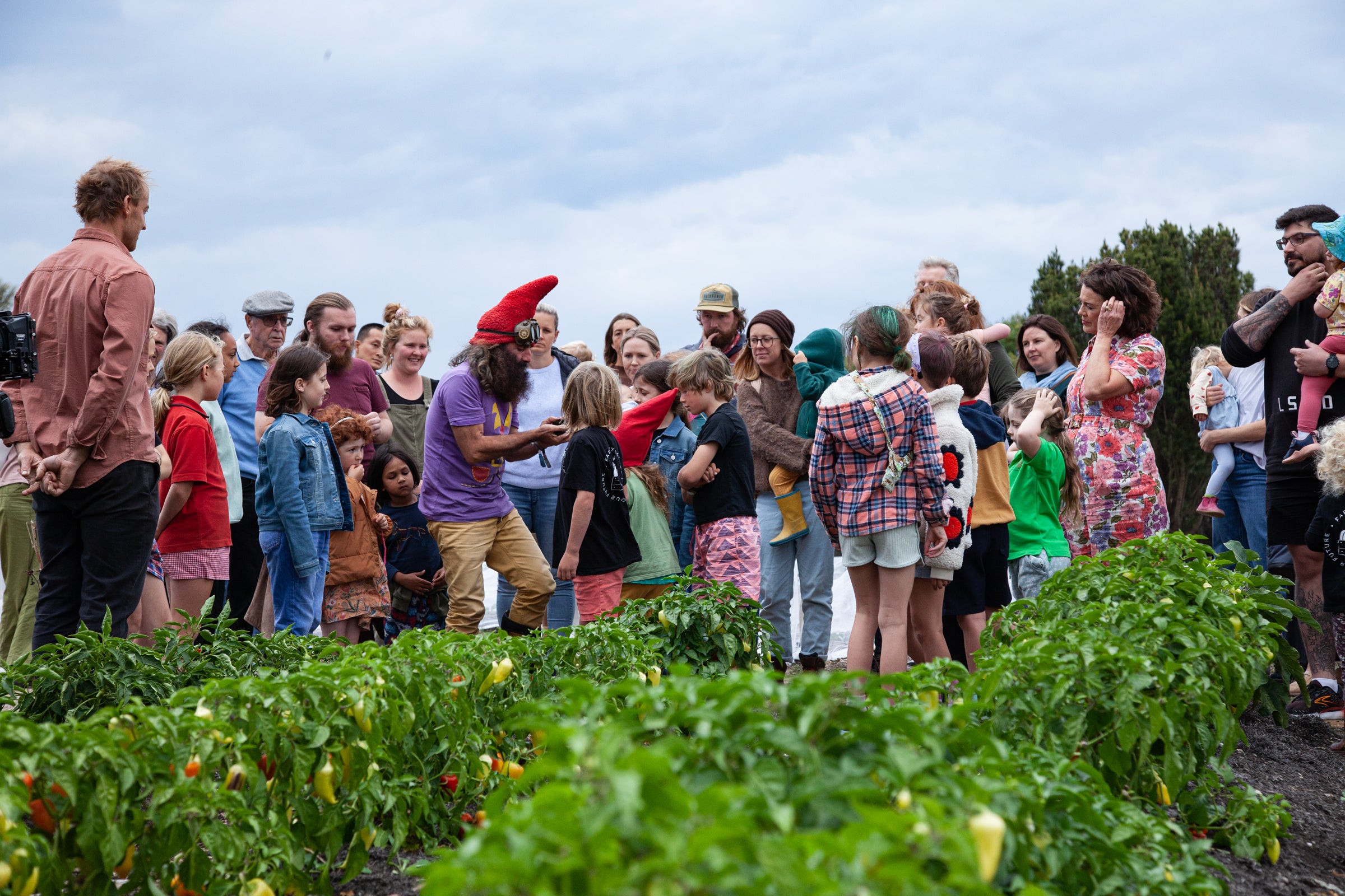 Children and families learning together in a school market garden, showing how donations to Farm My School help grow future leaders